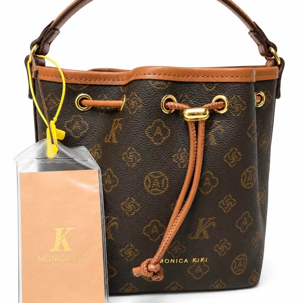 Monica Kiki brown bucket bag with repeating gold monogram pattern #monica #kiki